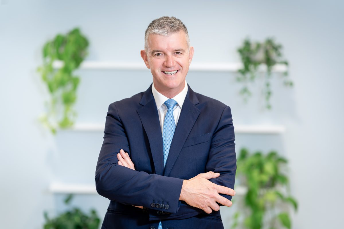 Mark Jeynes CIL education partner standing in suite and smiling 