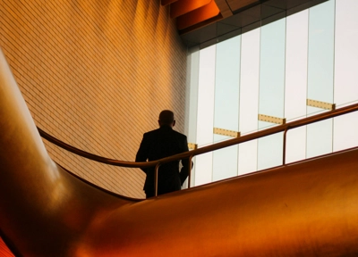 man standing in building about to discuss corporate strategy man standing in building about to discuss corporate strategy