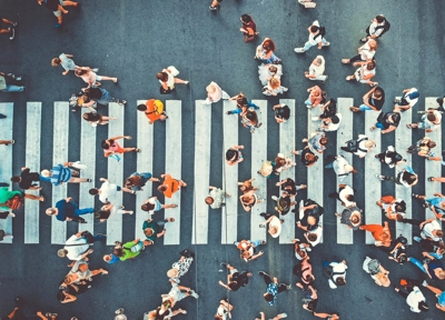 people walking across zebra crossing in shopping district people walking across zebra crossing in shopping district